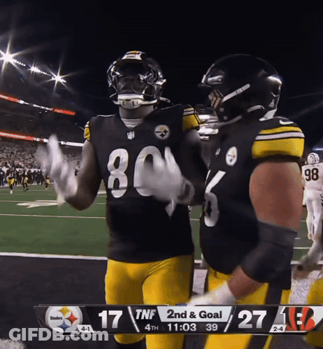 Football Players Near Scoreboard GIF