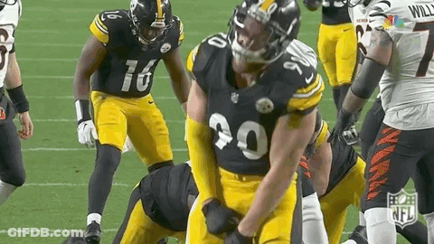 Football Players On Field One Holding Pants Up GIF