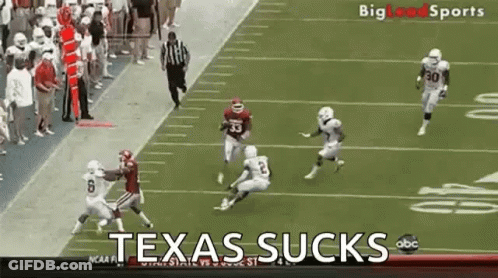 Football Players On Field Saying Texas Sucks GIF