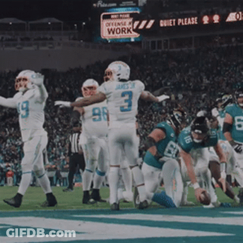 Football Players On Field With Quiet Please Sign GIF