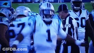 Football Players On Field With Referee GIF