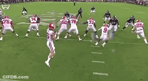 Football Players Playing On Field In Stadium GIF