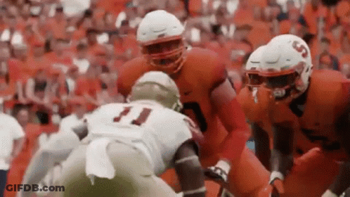 Football Players Playing On Field With Crowd GIF