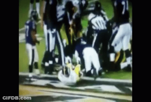 Football Players Playing One Lying On Ground GIF