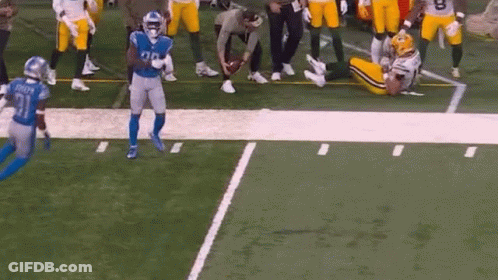Football Players Playing, One Lying GIF