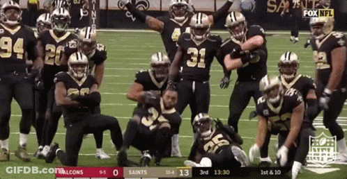 Football Players Posing On Field GIF