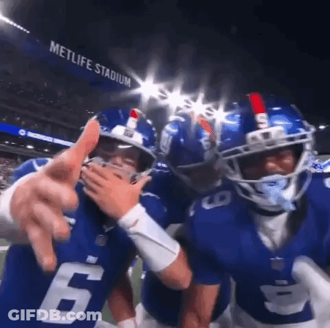 Football Players Posing On Field GIF