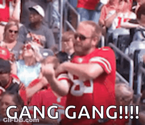 Football Players Running Across Field GIF
