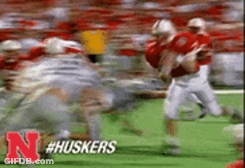 Football Players Running On Field With Letter N GIF