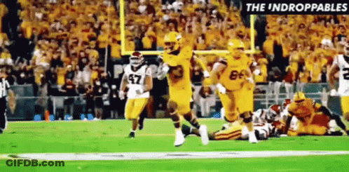 Football Players Running With Referee GIF