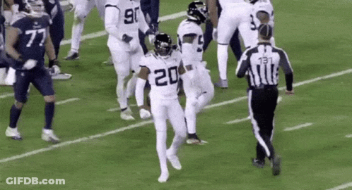 Football Players Running With Referee GIF