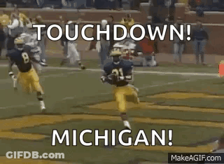 Football Players Running With Touchdown Michigan GIF