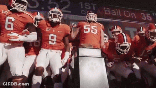 Football Players Standing In Front Of Ball On 38 Sign GIF