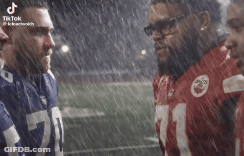 Football Players Standing In Rain GIF