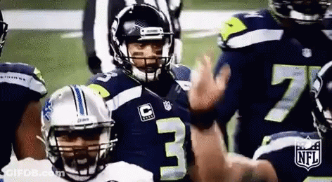 Football Players Standing On Field With Referee GIF