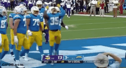 Football Players Walking On Field During Game GIF