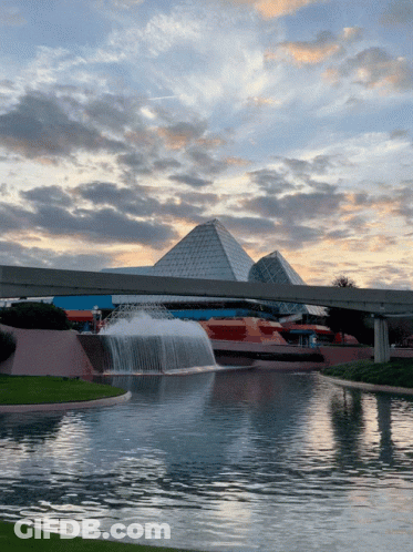 Fountain In Front Of Building With Pyramids GIF