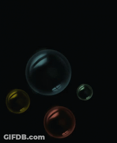 Four Colorful Bubbles Floating In Dark GIF