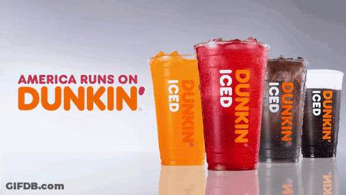Four Cups Of Dunkin ' Iced Drinks Are Lined Up In Front Of A Sign That Says America Runs On Dunkin ' GIF