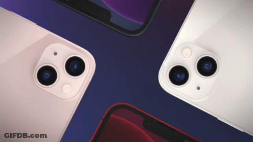 Four Different Colored Iphones Are Laying On Top Of Each Other On A Blue Surface GIF