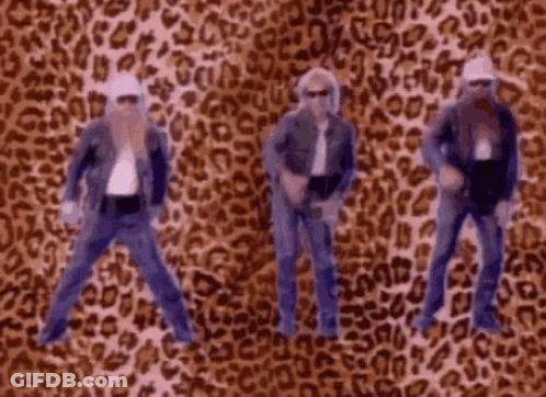 Four Men Dancing In Front Of Leopard Print Background GIF