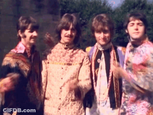Four Men In Colorful Shirts Standing Together GIF