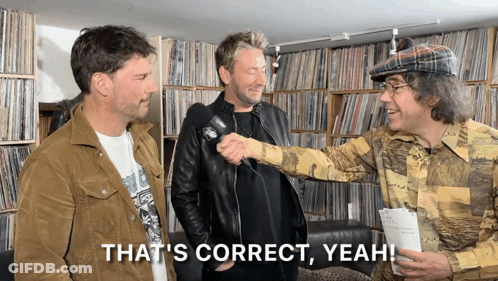 Four Men In Headphones Laughing, One Shirt Says Guitar Killer GIF