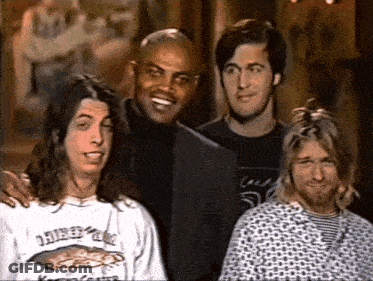 Four Men Posing One Wearing Nirvana Shirt GIF