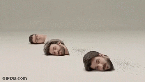 Four Men 'S Heads Are Sticking Out Of A Hole In The Ground . GIF