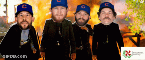 Four Men Wearing Blue Hats With The Letter C On Them Stand In Front Of A Fire GIF