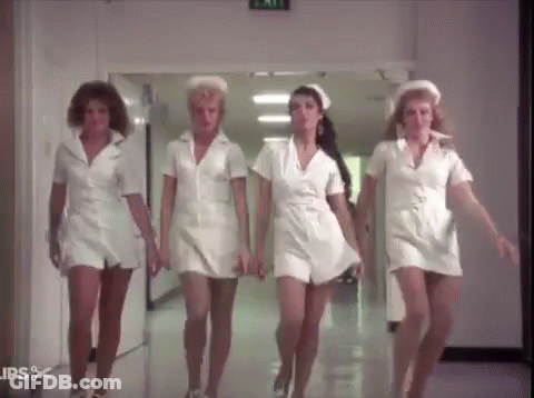 Four Nurses Walking Down Hospital Hallway GIF