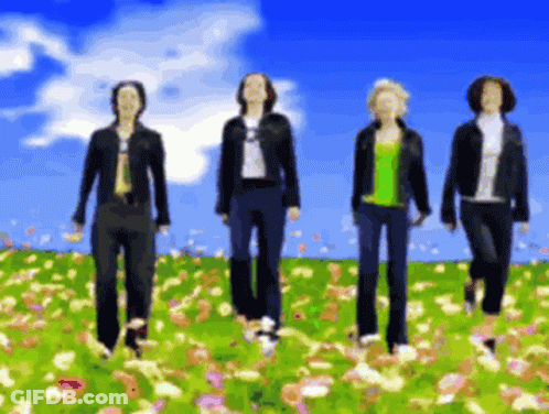 Four People Walking In Flower Field Blue Sky GIF