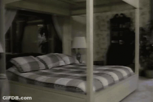 Four-Poster Bed In Bedroom With Lamp GIF