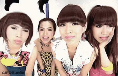 Four Women Are Posing For A Picture And One Has A Feather On Her Head GIF