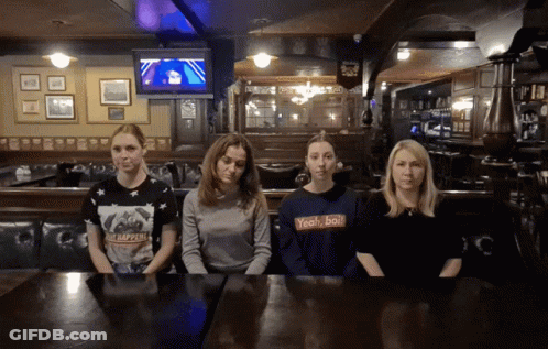 Four Women At Table One Wearing Yeah/Ball Shirt GIF