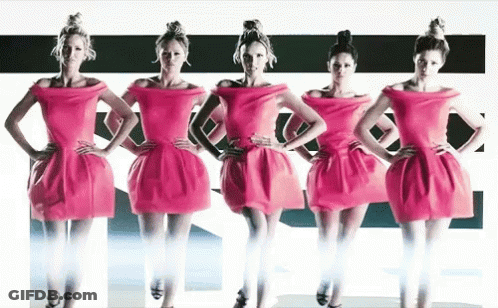 Four Women In Pink Dresses Are Standing Next To Each Other GIF