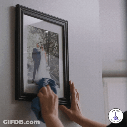 Framed Bride And Groom Cleaned With Blue Cloth GIF