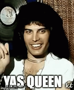 Freddie Mercury Is Smiling And Giving A Thumbs Up In Front Of A Record . GIF