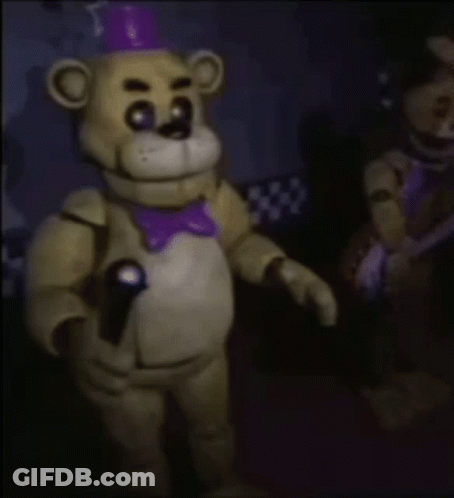 Freddy Fazbear From Five Nights At Freddy 'S Is Holding A Microphone In His Hand . GIF