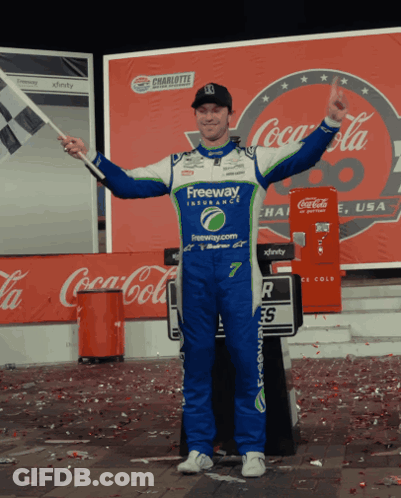 Freeway Uniform Man Holds Flag By Coca Cola GIF
