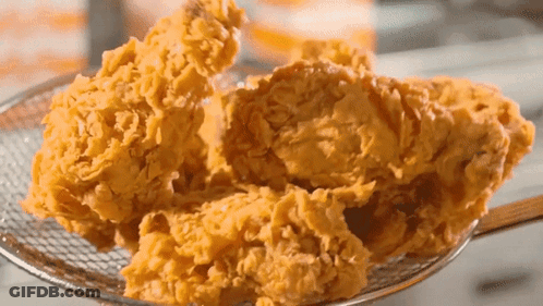 Fried Chicken Is Being Scooped Out Of A Basket GIF