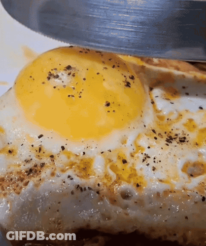 Fried Egg Being Cut With Knife GIF