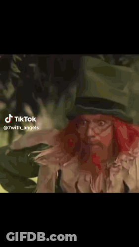 Frog In Red Dress And Black Cape Walking In Grass GIF