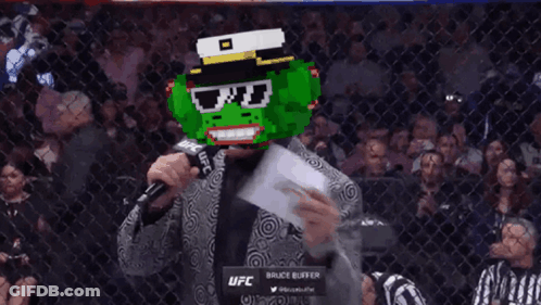 Frog Mask Man Talking Into Bruce Buffer Microphone GIF