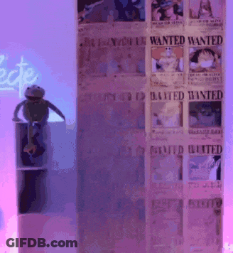 Frog Sitting On Shelf In Front Of Wanted Posters GIF