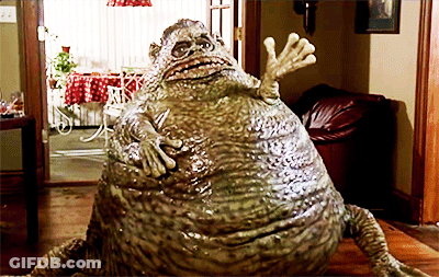 Frog Statue Sitting On Wooden Floor GIF