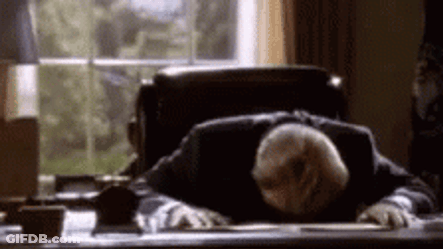Frustrated Man Bangs Head Against Wall GIF