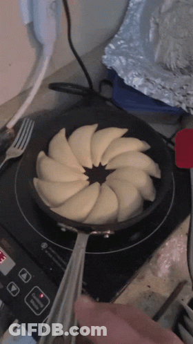 Frying Pan With Sliced Apples On Stove GIF