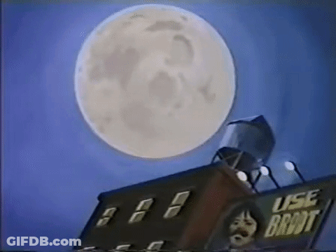 Full Moon Over Building With Water Tower GIF