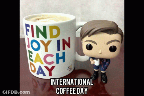 Funko Figure Holding Coffee Next To International Coffee Day Mug GIF